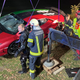 A red, green and black striped Lamborghini is lifted out a lake